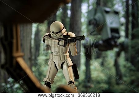 JUNE 1 2020: scene from Star Wars Return of the Jedi with an Imperial Stormtrooper firing his E-11 blaster on the forest moon of Endor - Hasbro action figure