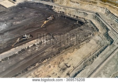 Aerial Shoot Of Quarry With Heavy Bucket Wheel Excavators Mining A Coal. Heavy Industry Concept.