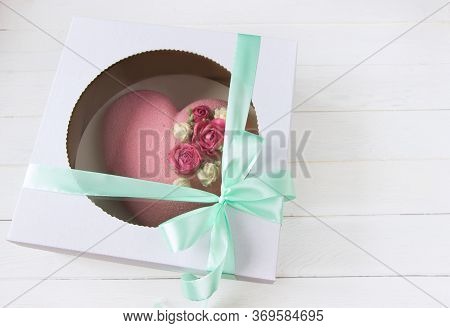 Delivery Box With Mousse Cakes .heart Shape Cake Decoraited Of Pink Roses. Box With Bow, White Backg