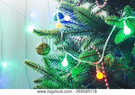 Christmas Decorations And Toys On Artificial Spruce, New Year Atmosphere.