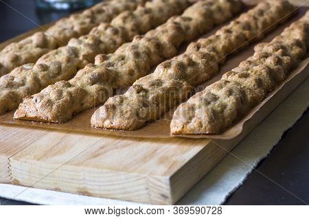 Italian Biscotti In The Process Of Preparation- Billets From Sweet Dough With Almonds, Baked On Bake