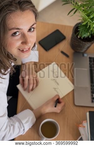 Woman Working On Laptop At Home Office While Drinling Coffee. Web Conection