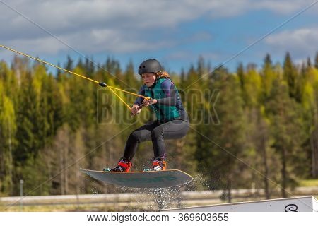 Fagersta, Sweden - Maj 26, 2020: Wakeboarder Flies In The Air On Wakeboard. Wakeboarding Is Extreme 