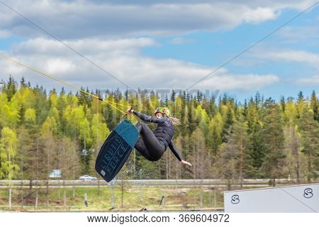Fagersta, Sweden - Maj 26, 2020: Wakeboarder Flies In The Air On Wakeboard. Wakeboarding Is Extreme 