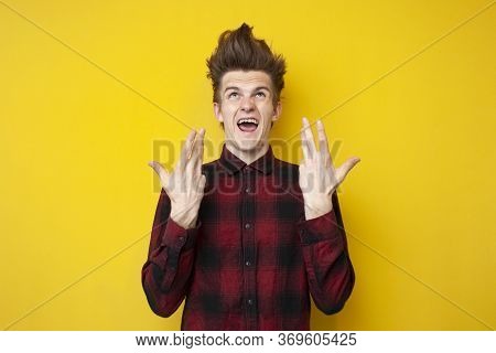 Nervous Guy With A Funny Hairstyle Getting Angry On A Yellow Isolated Background, Hipster Is Showing