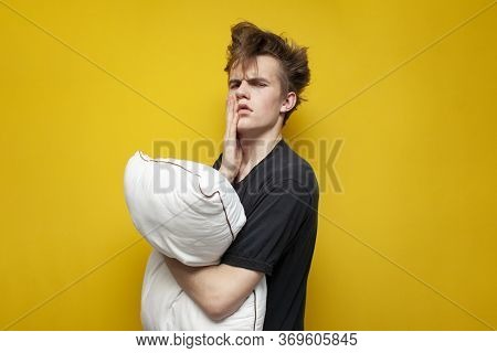 Tired Sleepy Guy With A Pillow Is Sad On A Yellow Background, Sleep Problem