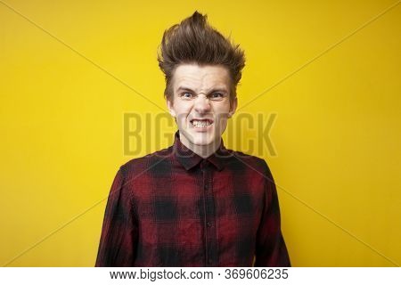 Aggressive Guy Gets Angry And Looks On A Yellow Isolated Background, Annoyed Man, Close-up
