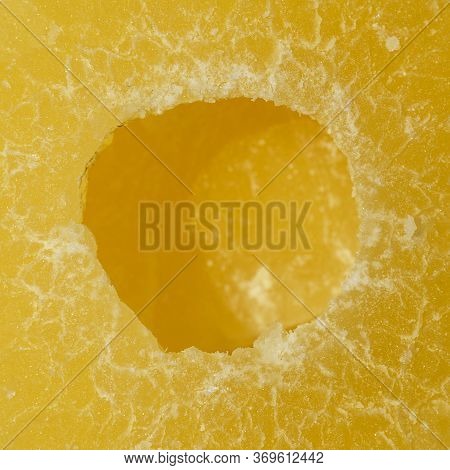 Yellow Pineapple Sweets Cut In Round Slices In Powdered Sugar.
