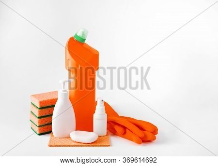 Plastic Bottles For Washing Dishes, Gloves And Sponges On A White Background.