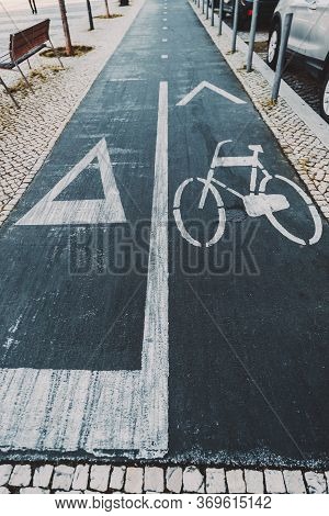 Wide-angle Vertical View Of A Road Marking Sign On Asphalt On A Bicycle Lane and The Running Track, 