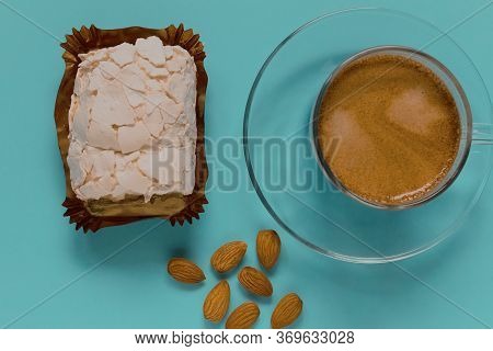 A Glass Cup Of Black Coffee With Merinque Cake And Almond. Top View.
