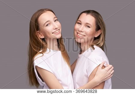 Elder Mother And Teenager Daughter Hug. Happy Family Portrait. Similar Smile. Next Generation Love. 