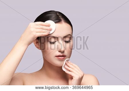 Girl Remove Mascara. Cotton Pad. Skin Care Evening Routine. Demakeup Cleaning Procedure. Young Woman