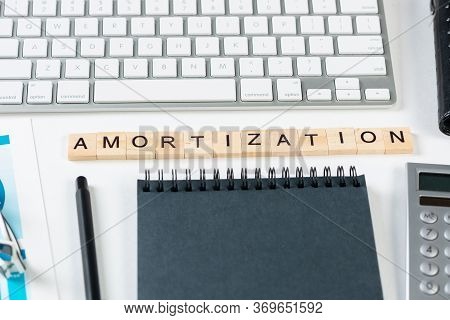 Amortization Expense Concept With Letters. Still Life Of Office Workplace With Supplies. Flat Lay Wh