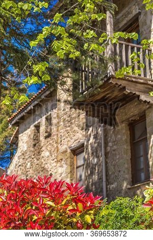 Red And Green Leaves And Defocused Building Of Meteora Monastery, Trikkala, Greece