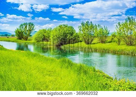 Beautiful Green Landscape, River Gacka Flowing Between The Meadow Fields In Lika Region Of Croatia