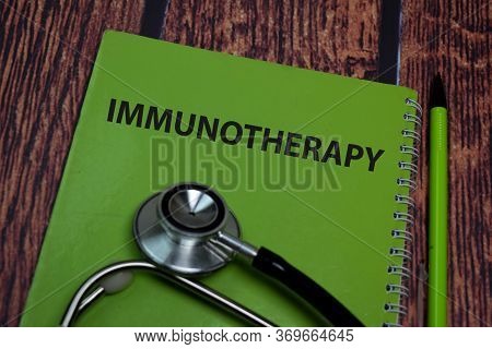 Book About Immunotherapy Isolated On Wooden Table.