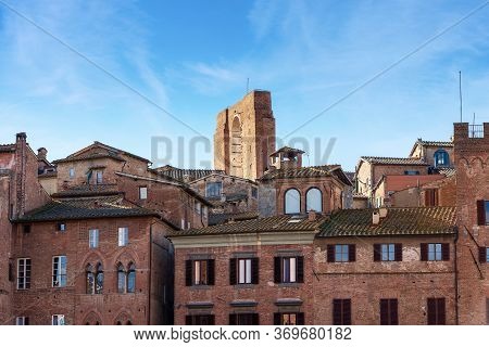 Cityscape Of Siena With Ancient Houses In Piazza Del Campo And The Facciatone (large Facade) Of The 