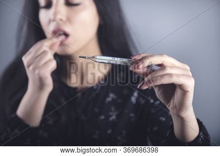 Young Ill Woman Hand Drug And Thermometer
