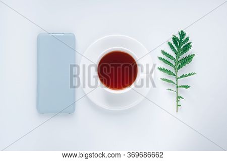 Flat Lay Cozy Morning. Start Of The Day, Insparation Concept. White Cup Of Tea, Smart Phone In Light