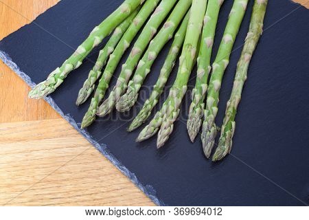 Asparagus Tips Against A Black Slate Background