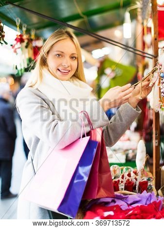 Portrait Of Female Customer Near Counter With Christmas Gifts