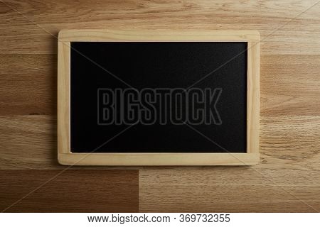 Blank Blackboard On The Wood Wall Background
