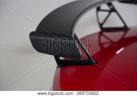 Close Up Of A Carbon Fibre Spoiler On A Red Sports Car