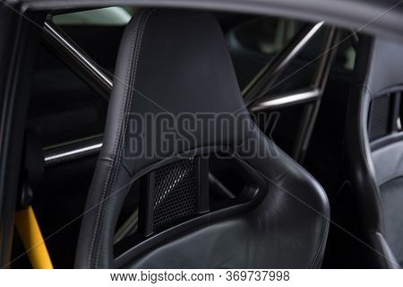 Detail Shot Of A Headrest On A Black Leather Bucket Seat