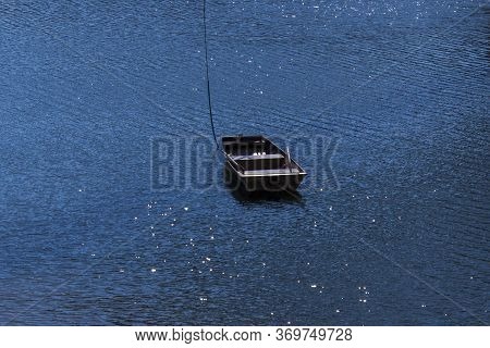 Little Boat In The Middle Of The Dam - The Water In The Sun Shimmers