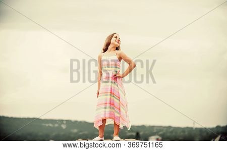 Good Mood At Any Weather. Carefree Child In Summer Dress. Small Girl With Long Curly Hair. Childhood