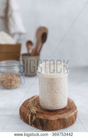 Close-up Of Jar With Natural Homemade Sourdough Levain Starter For Homemade Bakery