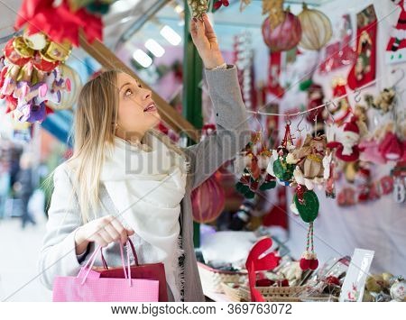Portrait Of Female Customer In Casual Outwear Near Counter With Christmas Gifts