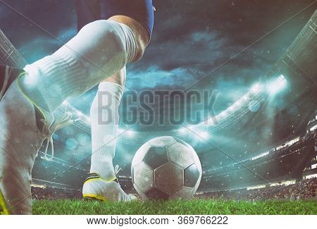 Close Up Perspective Of A Soccer Scene At Night Match With Player Kicking The Ball