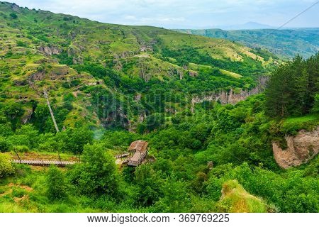 Panoramic View Of The Ancient Cave City Khndzoresk In The Mountains Of Armenia, With A Suspension Br