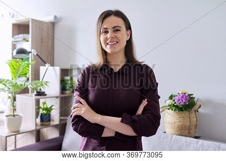 Portrait Of Smiling Beautiful Confident Woman 25 Years Old Looking At The Camera With Arms Crossed
