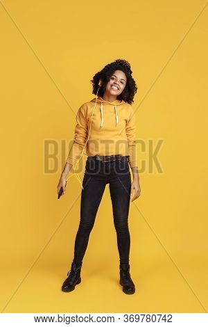 Full Lengh Image Of Positive African American Young Woman Dressed In Casual Clothes Over Yellow Back