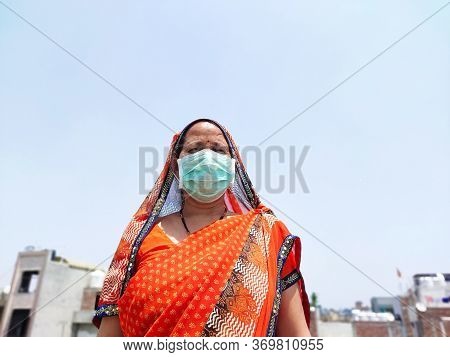 Indian Woman In Saari Wearing Face Mask For Corona Virus Protection.