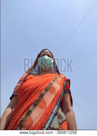 Indian Woman In Saari Wearing Face Mask For Corona Virus Protection.