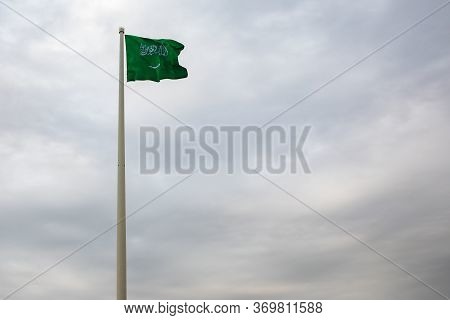 Kingdom Of Saudi Arabia Flag With Cloudy Sky