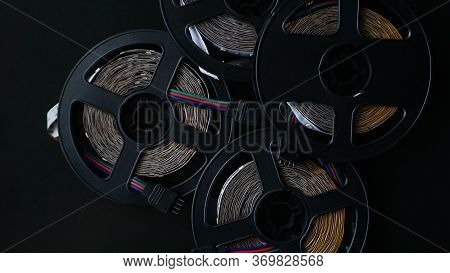 Coils Of Rgb Led Strip On A Black Table. Led Strip For Creative Lighting Collected In A Black Coil, 