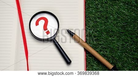 Magnifying Glass On White Sheet Of Notepad, Top View