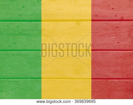 Mali Flag Painted On Wood Plank Background. Brushed Natural Light Knotted Wooden Board Texture. Wood