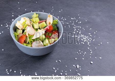 Fattoush Vegetarian Salad In A Gray Bowl Against Black Background. Copy Space. Close Up. Levantine S