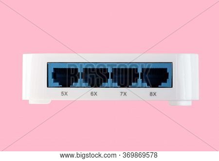 White 8 Port Plastic Ethernet Switch Isolated On Pink Background At Dry Day