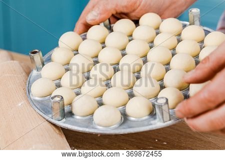 The Cook In The Kitchen Makes Dumplings. The Concept Of Cooking.