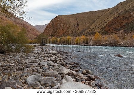 The Rocky Shore Of A Mountain River. Kokemeren River, Mountain River In The Naryn Region Of Kyrgyzst