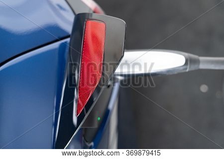 Tesla Car Electric Vehicle Plugged In And Charging