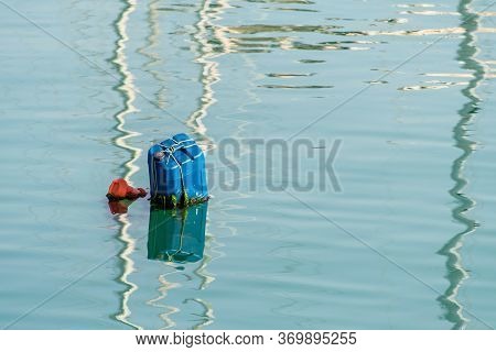 Colorful Handmade Buoy In Deep Blue Sea Waters On Sunset. Pilotage Marking Maritime Channel