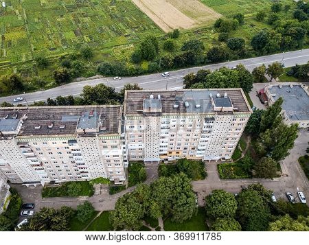 Aerial View Of Town With Socialist Soviet Panel Building At Cloudy Day. Buildings Were Built In The 